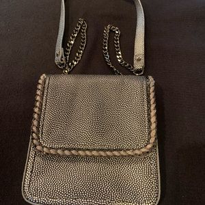 Beautiful Henri Bendel crossbody that can adjust to a small handbag.
